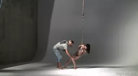 Photoshoot of a brunette submissive tied up like a slave