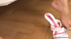 She fucks herself with a dildo while nibbling her toes