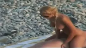 Voyeur on the beach films a couple having sex
